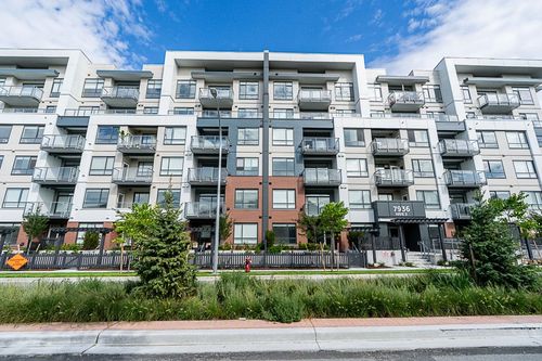Multi-story building with a contemporary facade, featuring multiple balconies with glass railings | Card Image