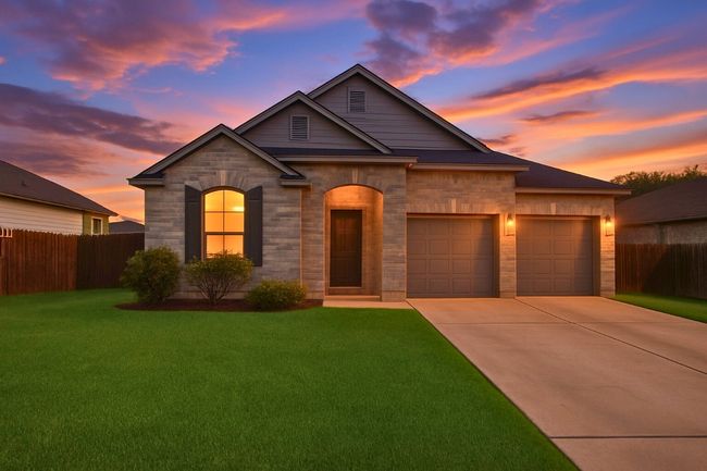 View of front of house featuring concrete driveway, an attached garage, and stone siding | Image 4