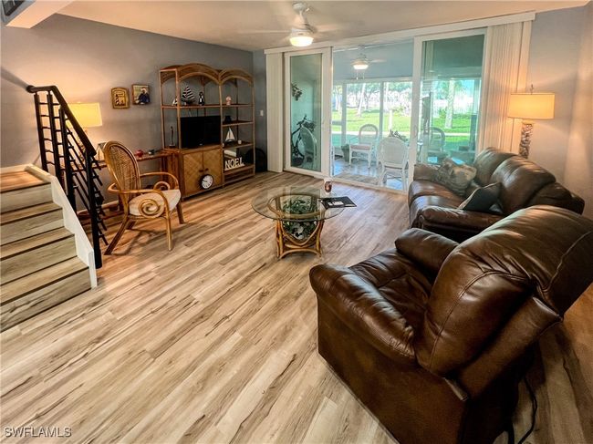 Living room with ceiling fan and light hardwood / wood-style flooring | Image 6