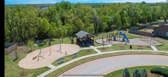 View of property's community with playground community, a yard, and a forest view | Image 29