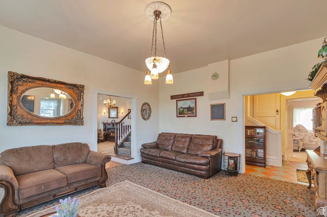 Living room with light tile patterned floors and a chandelier | Image 22