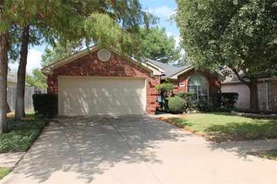 Single story home with a garage and a front lawn | Image 1