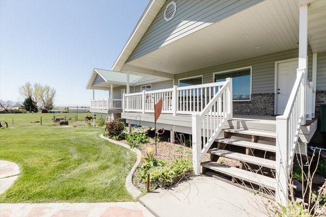 View of home's exterior with a yard and a wooden deck | Image 17