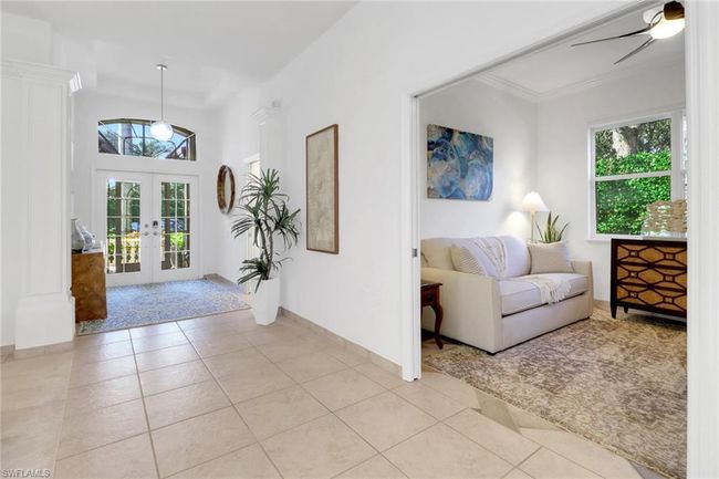 Entrance foyer featuring crown molding, baseboards, ceiling fan, french doors, and light tile patterned floors | Image 4