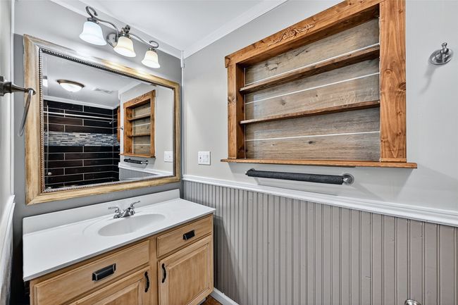 Bathroom featuring wainscoting, vanity, and ornamental molding | Image 12
