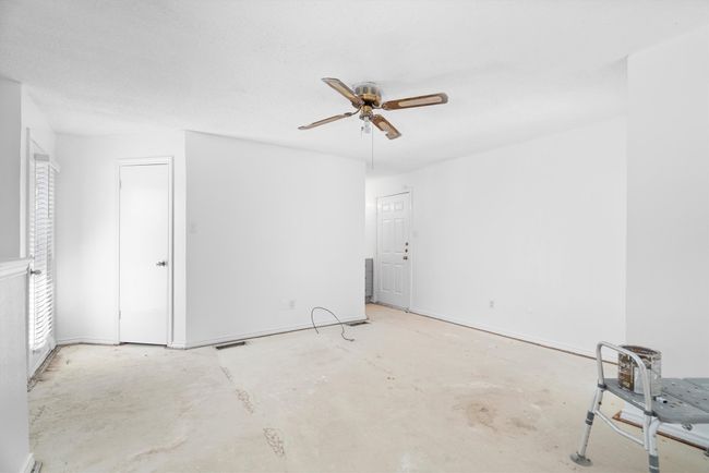 Empty room with unfinished concrete flooring and ceiling fan | Image 13