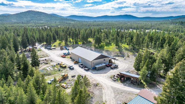 Aerial view of property and surrounding area featuring a heavily wooded area and mountains | Image 85