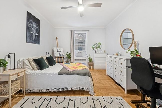 Bedroom with ornamental molding, ceiling fan, and cooling unit | Image 12