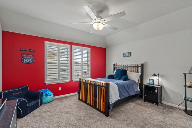 Carpeted bedroom featuring baseboards and a ceiling fan | Image 25