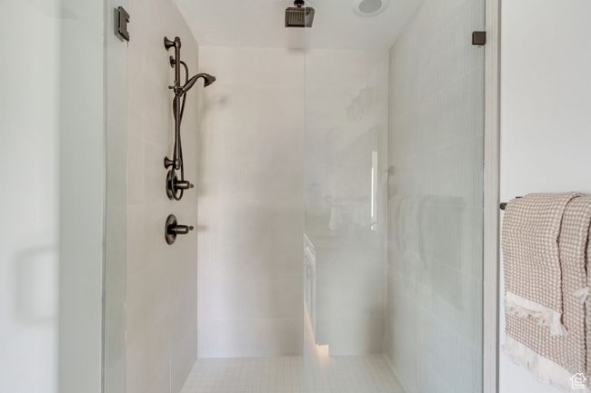 Full bath featuring a shower stall and tile walls | Image 9