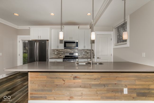 kitchen with white cabinets, stainless steel appliances, a sink, and recessed lighting | Image 17