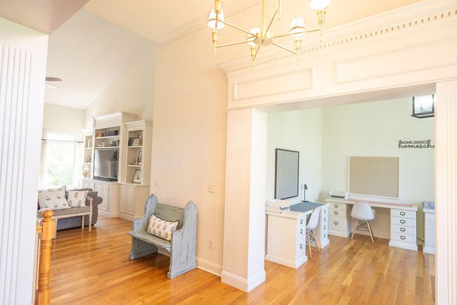 View from dining room into great room and living room. Look at the detail of the trim. Beautiful hard wood floors. | Image 37