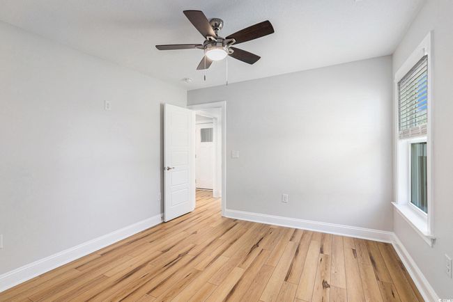 Spare room with light wood-style flooring and a ceiling fan | Image 22