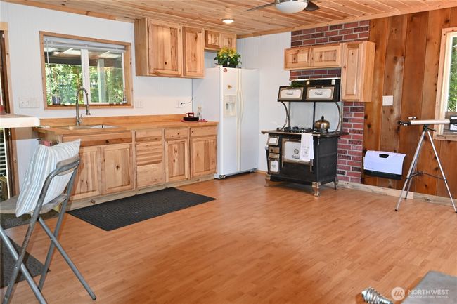 Newly painted kitchen that highlights the wood cabinetry. | Image 15