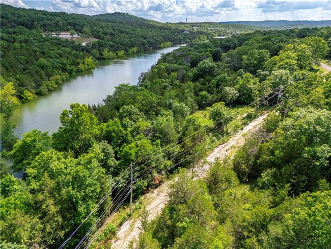 Bird's eye view of a heavily wooded area and a large body of water | Image 15