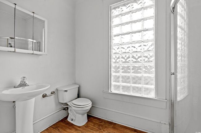 Bathroom with toilet and wood finished floors | Image 26