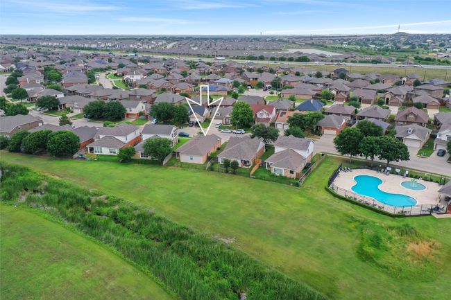 Aerial view of property and surrounding area featuring a pool area and nearby suburban area | Image 39