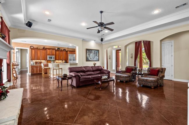 Archway view into the gourmet kitchen highlights seamless connection—perfect for any occasion. | Image 12