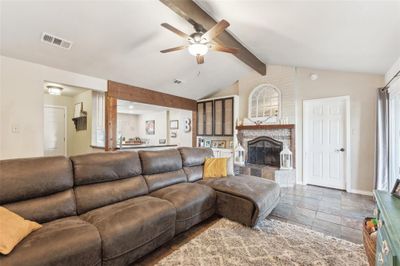 Living room featuring lofted ceiling with beams, ceiling fan, and tile patterned floors | Image 2