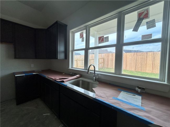 Kitchen with dark cabinets and a sink | Image 4