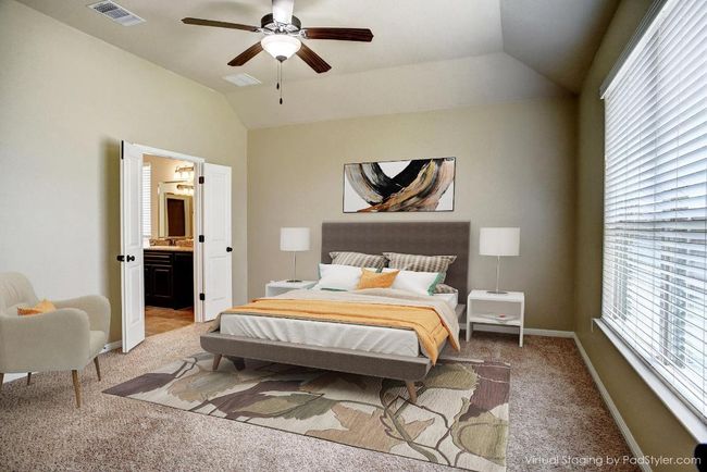 Bedroom featuring light carpet, lofted ceiling, ensuite bathroom, and a ceiling fan | Image 8