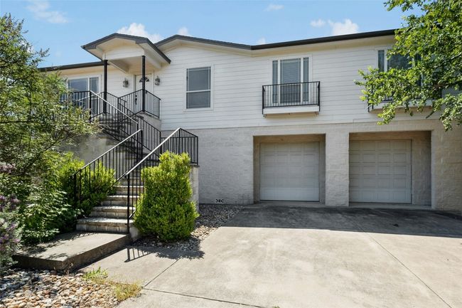 View of front of house driveway, a garage, and stairs | Image 33