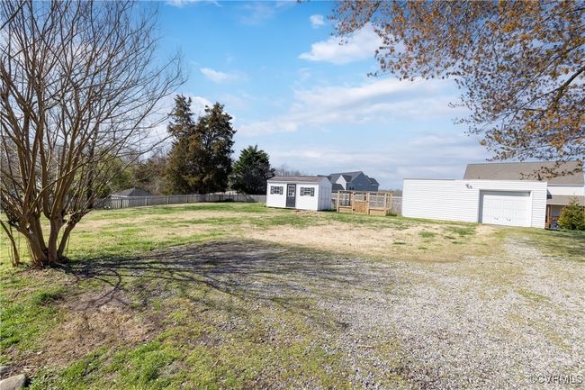 View of yard with an outbuilding, a shed, fence, driveway, and a garage | Image 31