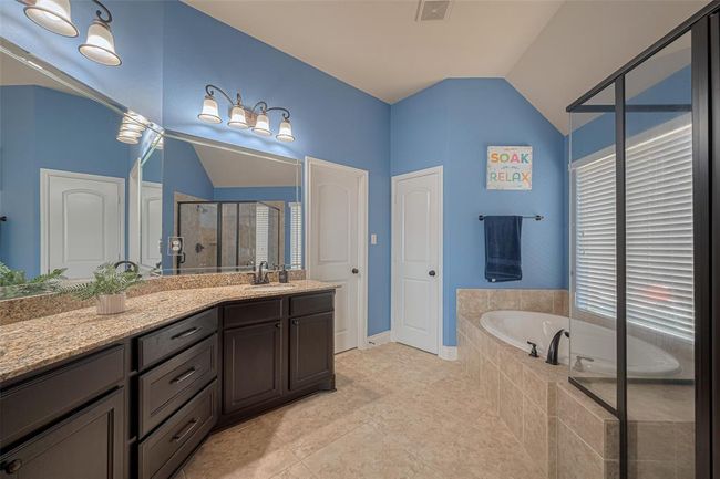 The primary bath leads into the walk-in closet featuring custom built-ins you won’t want to miss!!! | Image 25