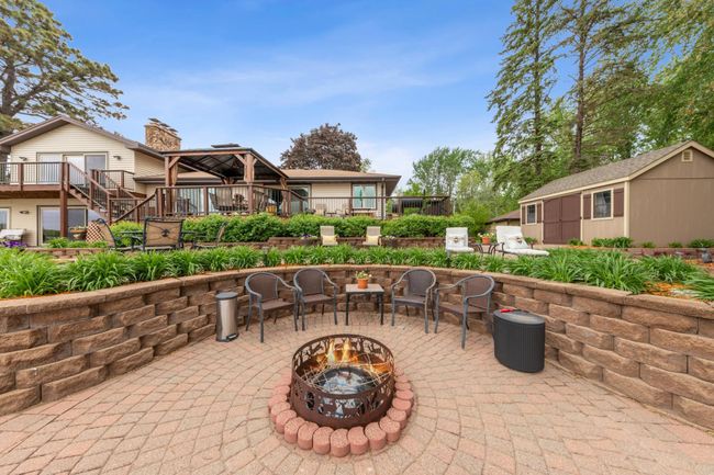 Entertaining patio with a built in bonfire pit and multiple levels of entertaining space | Image 41