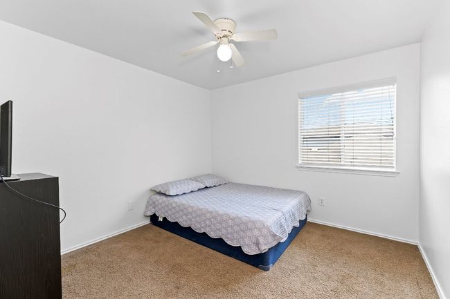 Bedroom with carpet and a ceiling fan | Image 25