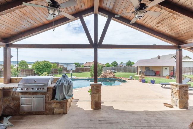 View of patio featuring area for grilling, a ceiling fan, and a deck | Image 30