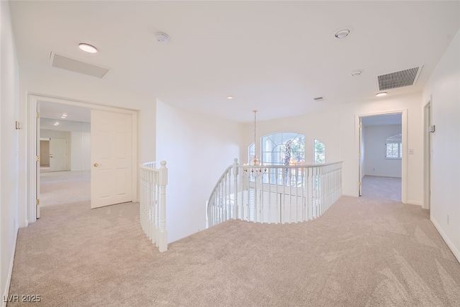 Corridor featuring carpet floors, visible vents, and an upstairs landing | Image 45