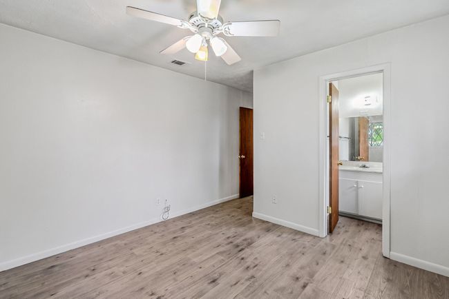 Empty room featuring light wood-style floors and a ceiling fan | Image 10