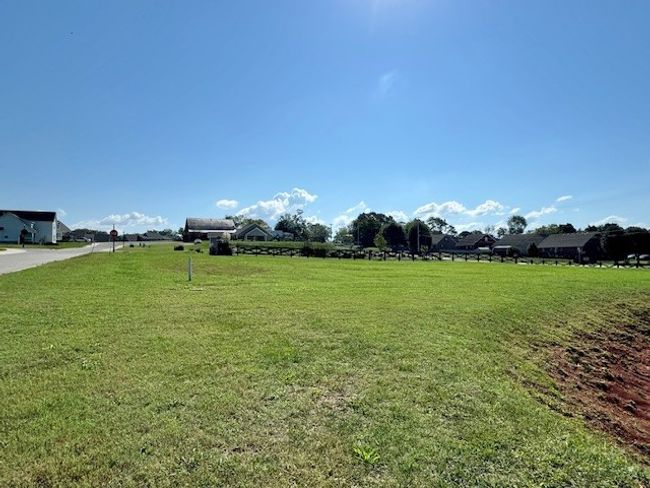 The small retention pond adjoining Lot 504 is most often completely dry and provides even greater space between property lines; a nice benefit to this large corner lot! | Image 5