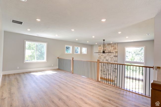 Empty room with wood finished floors and recessed lighting | Image 17