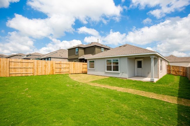 Rear view of property with a patio area, stucco siding, and a shingled roof | Image 26