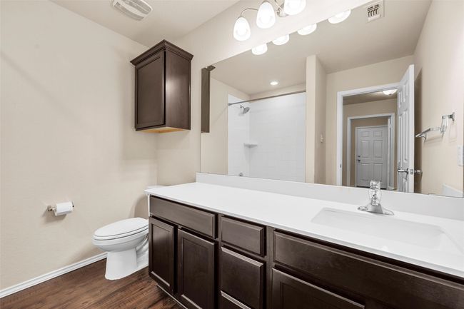 Bathroom with vanity, tiled shower, and wood finished floors | Image 22