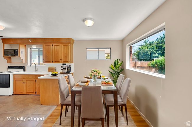 Dining room with light wood finished floors and baseboards | Image 5