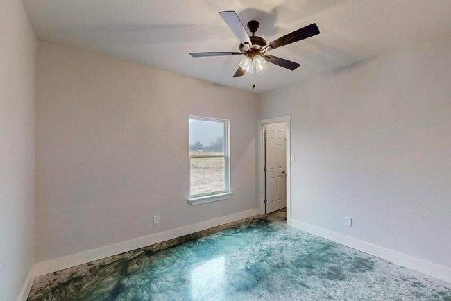 Unfurnished room with carpet flooring, baseboards, and a ceiling fan | Image 15
