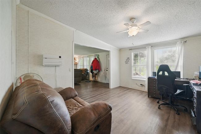 Office with a textured ceiling, ceiling fan, and wood finished floors | Image 9