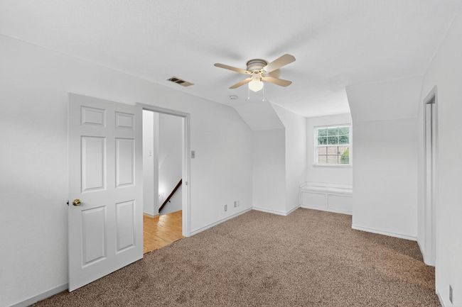 Additional living space featuring light colored carpet, a ceiling fan, and lofted ceiling | Image 25
