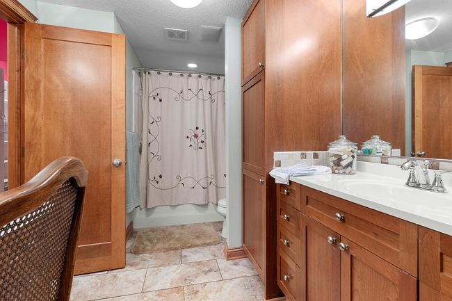 Lower-level second bedroom full bath and walk-in closet. | Image 58