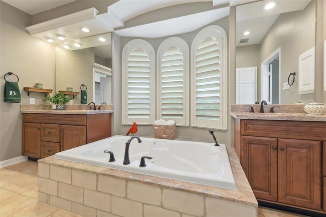 Primary bath with dual sinks, tons of storage including hidden storage at the base of the cabinets! | Image 25