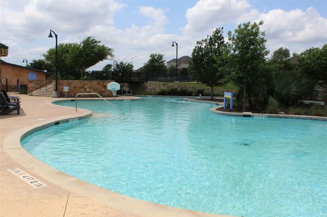 Community pool featuring fence, stairs, and a patio area | Image 34