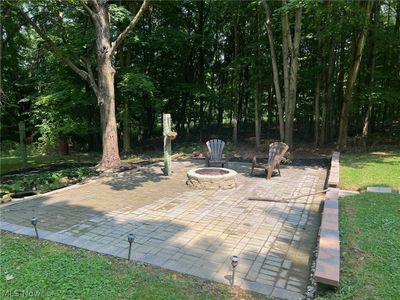 View of patio / terrace with an outdoor fire pit | Image 3