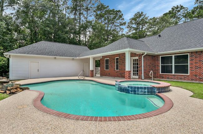 Pool with garage and main house in the back ground. | Image 40