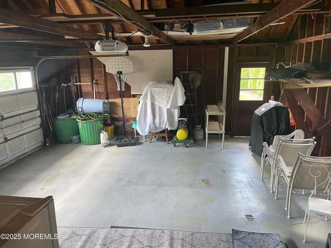 Two car garage with door to side yard with patio | Image 24