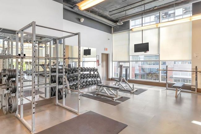 Gym featuring a towering ceiling | Image 24