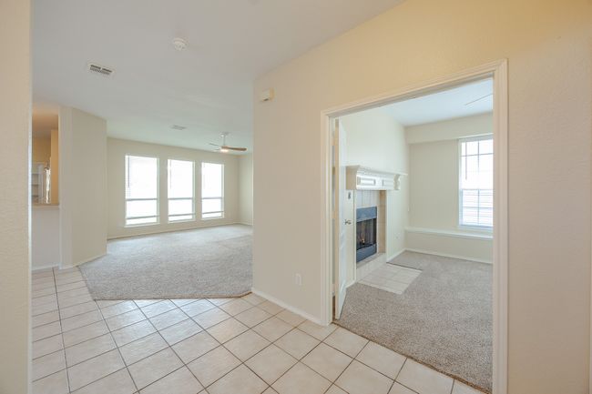 Hallway with light carpet and light tile patterned floors | Image 8