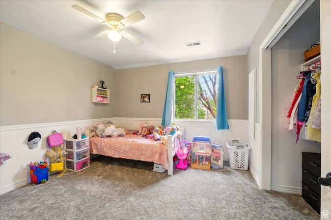 Bedroom featuring carpet flooring, a ceiling fan, and a closet | Image 32